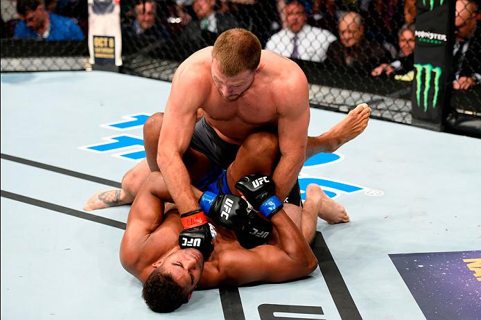 Stipe Miocic earns a TKO win over Alistair Overeem at UFC 203 to defend his heavyweight title