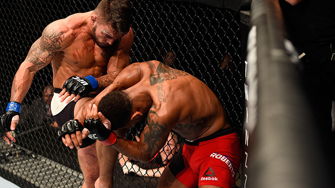 MANCHESTER, ENGLAND - OCT. 08: (L-R) <a href='../fighter/mike-perry'>Mike Perry</a> knees <a href='../fighter/danny-roberts'>Danny Roberts</a> of England in their welterweight bout during the UFC 204 Fight Night at the Manchester Evening News Arena. (Photo by Josh Hedges/Zuffa LLC)“ align=“center“ />Unbeaten welterweight prospect Mike Perry usually ends his fights in the first round, but Saturday at Manchester Arena, “Platinum” had to wait until 20 seconds were left in the fight to get his knockout victory, as he halted Danny Roberts in the third and final round of their exciting UFC 204 bout.<p>Perry was the aggressor throughout the first half of the opening round, but he was largely ineffective, as Roberts scored with several counter punches and kicks. With 2:20 remaining though, Perry finally caught up with Roberts and landed a hard knee that led Roberts into a takedown attempt that came up empty. While on the mat, Perry was in control, and by the end of the frame, the two were standing but it was Perry rocking his foe with several hard strikes that brought the fight back to the canvas.</p><p><strong>RELATED: <a href=