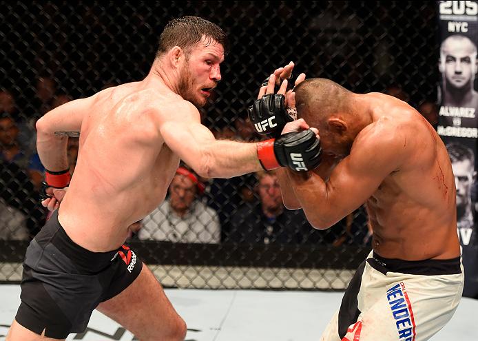 MANCHESTER, ENGLAND - OCTOBER 08: (L-R) Michael Bisping of England punches Dan Henderson in their UFC middleweight championship bout during the UFC 204 Fight Night at the Manchester Evening News Arena on October 8, 2016 in Manchester, England. (Photo by Josh Hedges/Zuffa LLC)