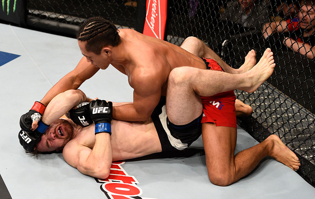 LAS VEGAS, NV - DECEMBER 03: (R-L) Dong Hyun Kim of South Korea punches Brendan O'Reilly of Australia in their lightweight bout during The Ultimate Fighter Finale event inside the Pearl concert theater at the Palms Resort & Casino on December 3, 2016 in Las Vegas, Nevada. (Photo by Jeff Bottari/Zuffa LLC)