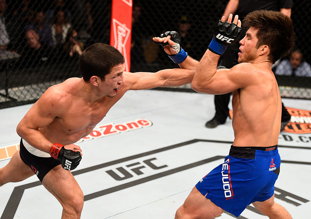 LAS VEGAS, NV - DECEMBER 03: (L-R) Joseph Benavidez punches Henry Cejudo in their flyweight bout during The Ultimate Fighter Finale event inside the Pearl concert theater at the Palms Resort & Casino on December 3, 2016 in Las Vegas, Nevada. (Photo by Jeff Bottari/Zuffa LLC)