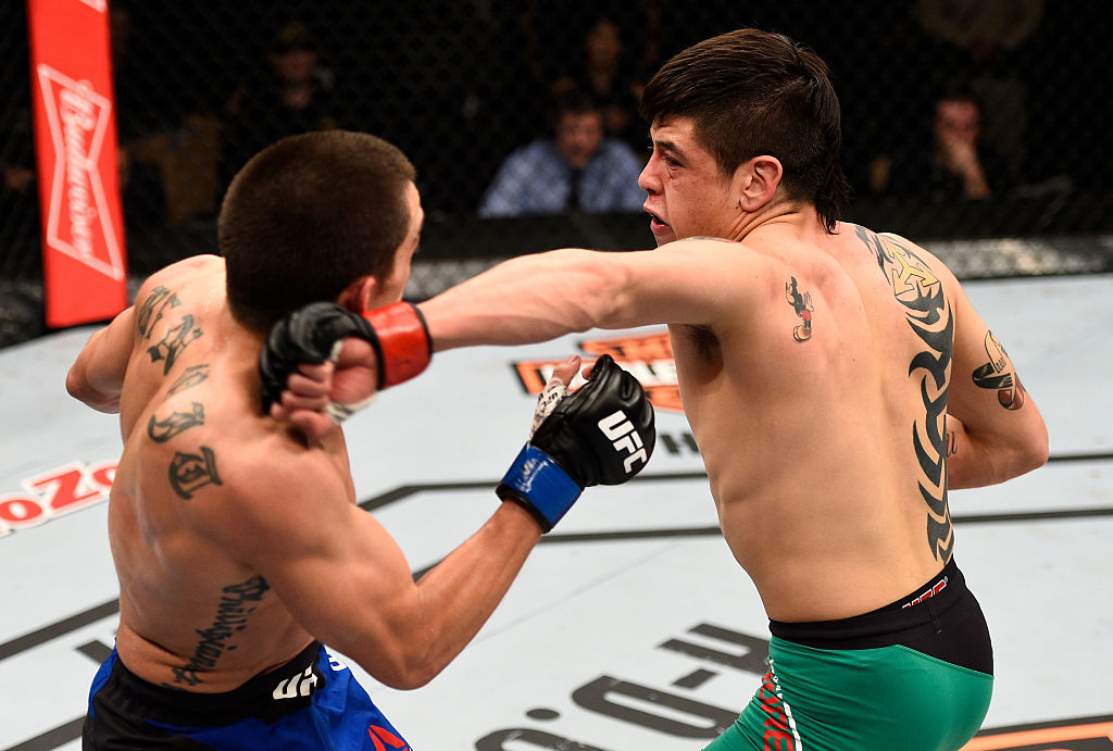 LAS VEGAS, NV - DECEMBER 03: (R-L) Brandon Moreno of Mexico punches Ryan Benoit in their flyweight bout during The Ultimate Fighter Finale event inside the Pearl concert theater at the Palms Resort & Casino on December 3, 2016 in Las Vegas, Nevada. (Photo by Jeff Bottari/Zuffa LLC)