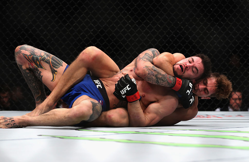 Niko Price attempts to submit Brandon Thatch in their welterweight bout (Photo by Christian Petersen/Getty Images)