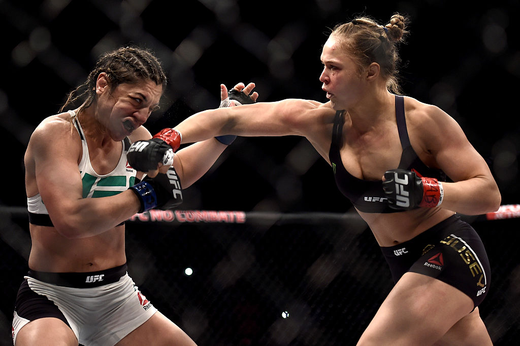 RIO DE JANEIRO, BRAZIL - AUG. 01: Ronda Rousey of the United States punches Bethe Correia of Brazil in their bantamweight title fight during the UFC 190 Rousey v Correia at HSBC Arena. (Photo by Buda Mendes/Zuffa LLC)
