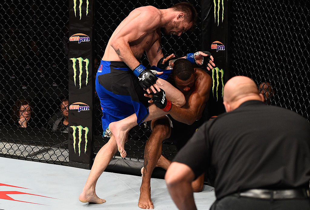  Tim Means knees Alex Oliveira of Brazil in their welterweight bout during the UFC 207 event at T-Mobile Arena on December 30, 2016 in Las Vegas, Nevada. (Photo by Jeff Bottari/Zuffa LLC/Zuffa LLC via Getty Images)