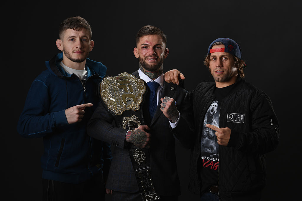 LAS VEGAS, NV - DECEMBER 30: UFC bantamweight champion Cody Garbrandt (C) poses with Urijah Faber (R) and Chris Holdsworth backstage during the UFC 207 event at T-Mobile Arena on December 30, 2016 in Las Vegas, Nevada. (Photo by Mike Roach/Zuffa LLC)