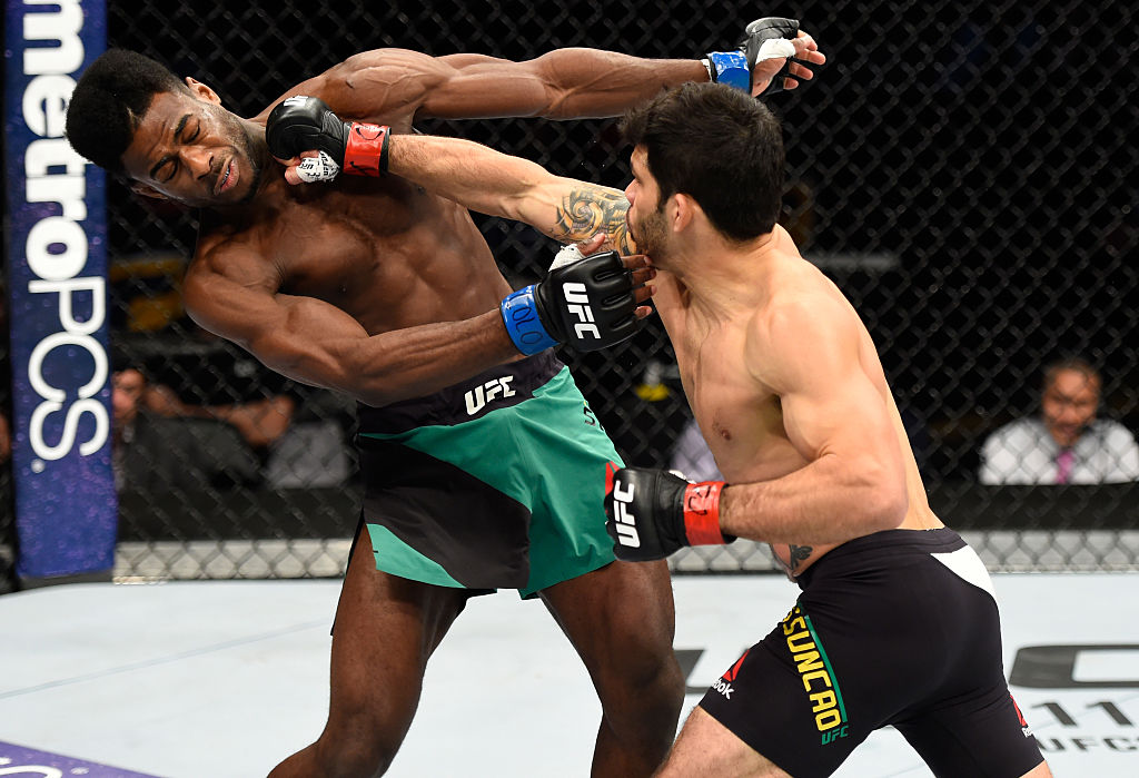 Raphael Assuncao punches Aljamain Sterling during their bantamweight bout at Fight Night Denver