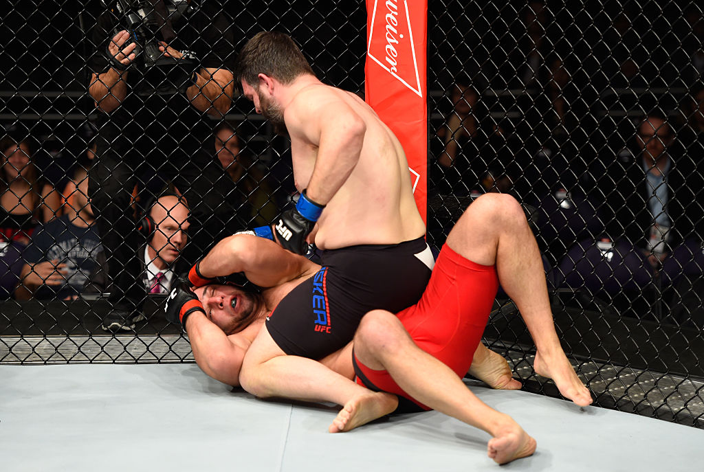 PHOENIX, AZ – JAN. 15: Cyril Asker of France (top) punches Dmitrii Smoliakov of Russia in their heavyweight bout during the UFC Fight Night event inside Talking Stick Resort Arena. (Photo by Jeff Bottari/Zuffa LLC)