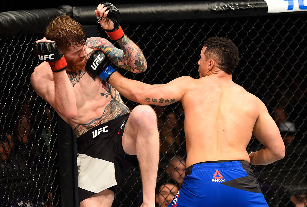 PHOENIX, AZ - JAN. 15: (R-L) Drakkar Klose punches Devin Powell in their lightweight bout during the UFC Fight Night event inside Talking Stick Resort Arena. (Photo by Jeff Bottari/Zuffa LLC)