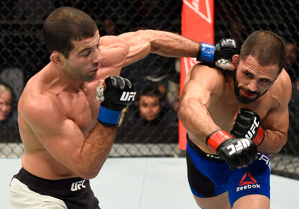 PHOENIX, AZ - JAN. 15: (L-R) Augusto Mendes of Brazil punches Frankie Saenz in their bantamweight bout during the UFC Fight Night event inside Talking Stick Resort Arena. (Photo by Jeff Bottari/Zuffa LLC)