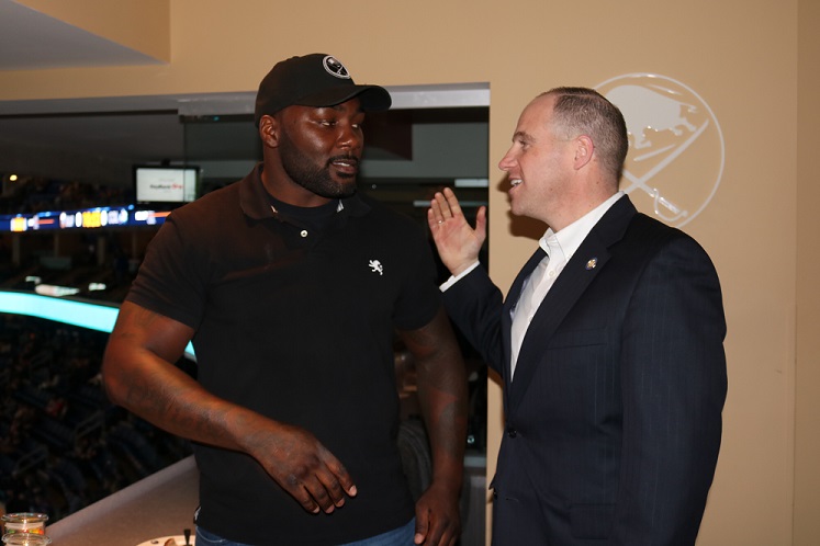No. 1 ranked light heavyweight Anthony Johnson (left) shares conversation with New York State Senator Tim Kennedy at a National Hockey League game between the Buffalo Sabres and Colorado Avalanche.