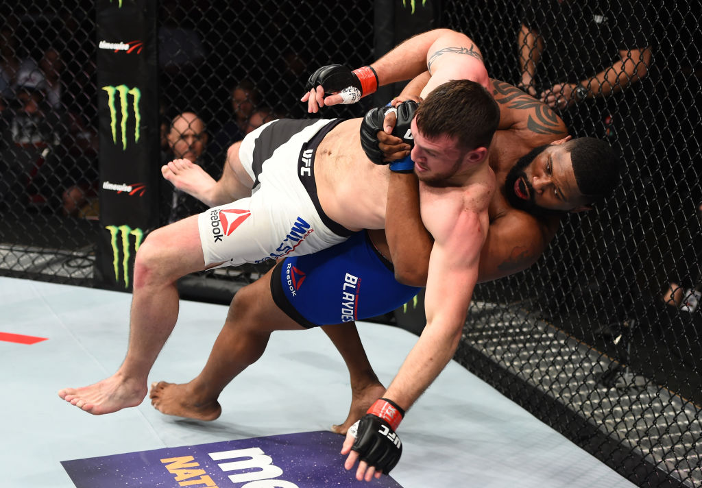 HOUSTON, TX - FEBRUARY 04: (R-L) Curtis Blaydes takes down Adam Milstead in their heavyweight bout during the UFC Fight Night event at the Toyota Center on February 4, 2017 in Houston, Texas. (Photo by Jeff Bottari/Zuffa LLC)