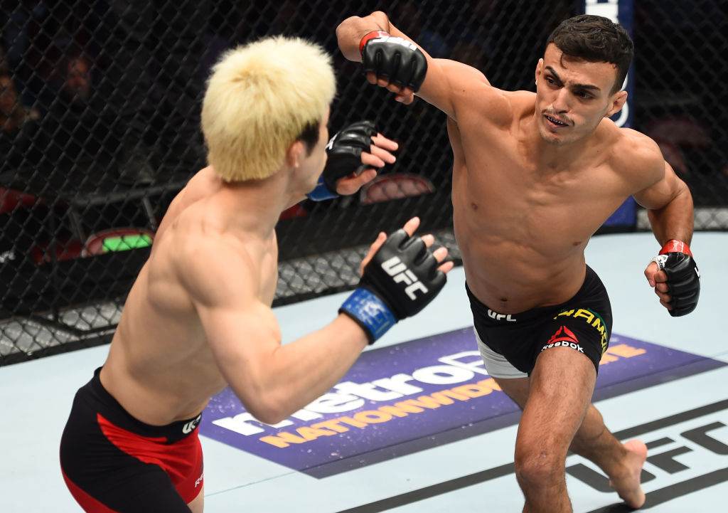 HOUSTON, TX - FEBRUARY 04: (R-L) Ricardo Ramos of Brazil punches Michinori Tanaka of Japan in their bantamweight bout during the UFC Fight Night event at the Toyota Center on February 4, 2017 in Houston, Texas. (Photo by Jeff Bottari/Zuffa LLC)