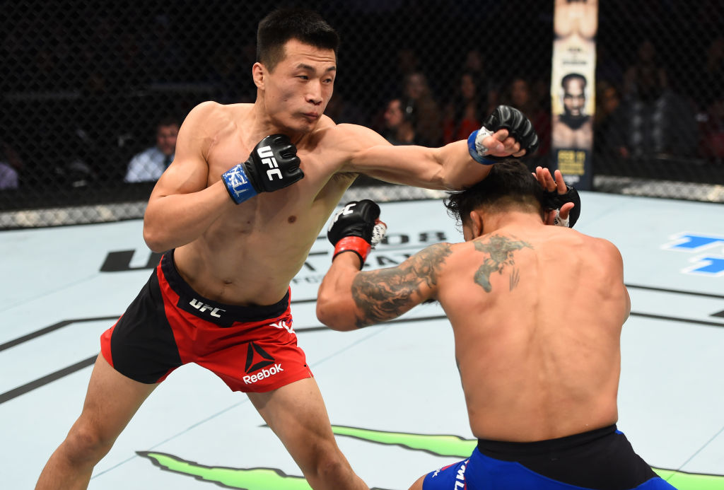 HOUSTON, TX - FEBRUARY 04: (L-R) Chan Sung Jung of South Korea punches Dennis Bermudez in their featherweight bout during the UFC Fight Night event at the Toyota Center on February 4, 2017 in Houston, Texas. (Photo by Jeff Bottari/Zuffa LLC)