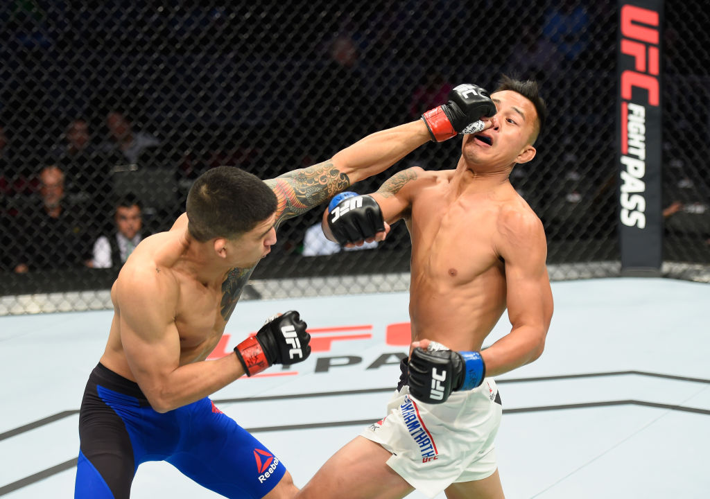 LAS VEGAS, NV - MARCH 04: (L-R) Albert Morales punches Andre Soukhamthath in their bantamweight bout during the UFC 209 event at T-Mobile Arena on March 4, 2017 in Las Vegas, Nevada. (Photo by Josh Hedges/Zuffa LLC)