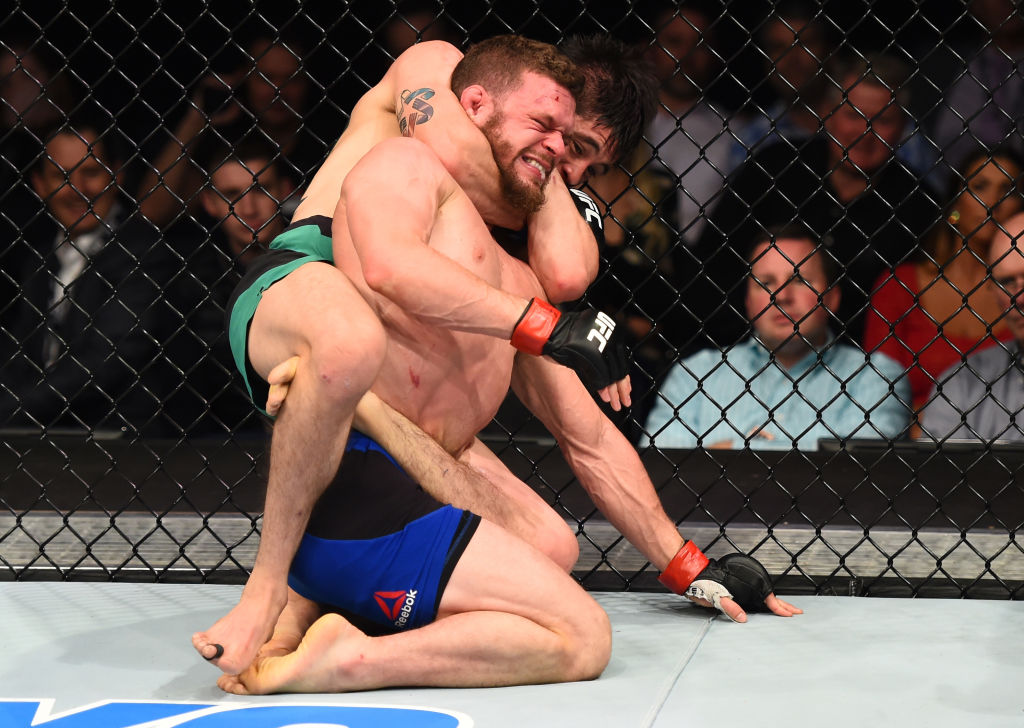 NASHVILLE, TN - APRIL 22: (L-R) Brandon Moreno of Mexico secures a rear choke submission against Dustin Ortiz in their flyweight bout during the UFC Fight Night event at Bridgestone Arena on April 22, 2017 in Nashville, Tennessee. (Photo by Jeff Bottari/Zuffa LLC)