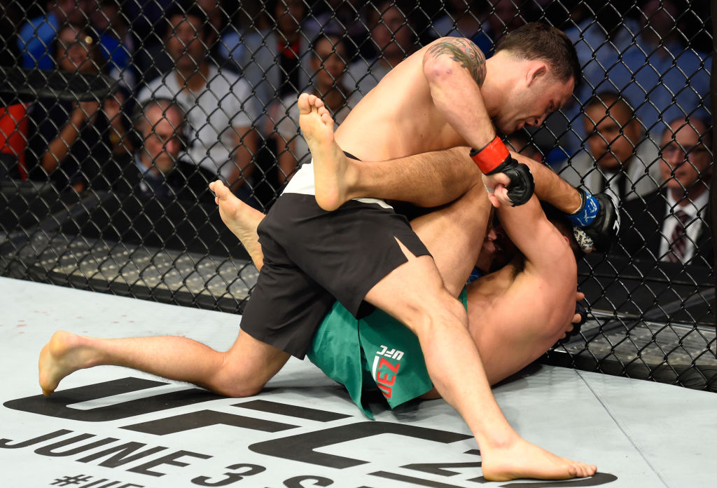 DALLAS, TX - MAY 13: Frankie Edgar (top) punches Yair Rodriguez in their featherweight fight during the UFC 211 event at the American Airlines Center on May 13, 2017 in Dallas, Texas. (Photo by Josh Hedges/Zuffa LLC)