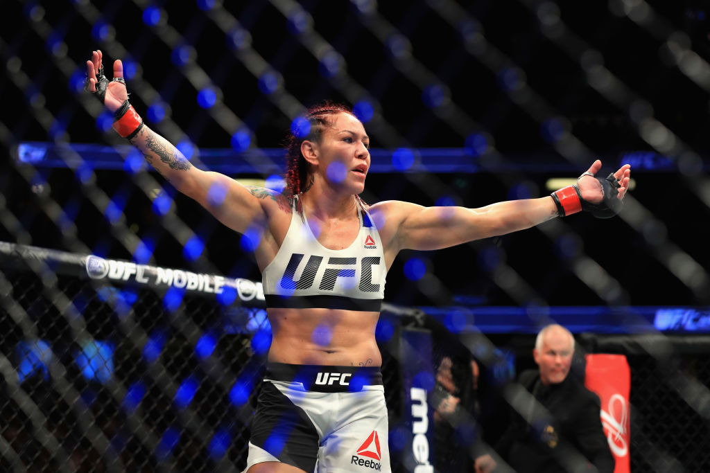 ANAHEIM, CA - JULY 29: <a href='../fighter/Cris-Cyborg'>Cris Cyborg</a> of Brazil reacts to defeating <a href='../fighter/Tonya-Evinger'>Tonya Evinger</a> during their Featherweight Title fight at UFC 214 at Honda Center on July 29, 2017 in Anaheim, California. (Photo by Sean M. Haffey/Getty Images)“ align=“center“/>A new UFC women’s featherweight champion was crowned on the UFC 214 card at Honda Center in Anaheim Saturday, as Cris “Cyborg” stopped Tonya Evinger in the third round.</p><p>The title makes it a triple crown for the 32-year-old Curitiba native, who was formerly the <a href=