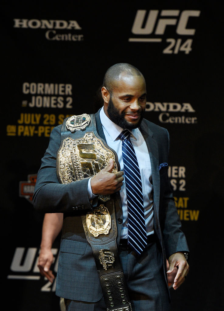 LOS ANGELES, CA - JULY 26: Daniel Cormier poses with the UFC belt after facing off with Jon Jones during the UFC 214 Press Conference at The Novo by Microsoft July 26, 2017 in Los Angeles, California. (Photo by Kevork Djansezian/Zuffa LLC