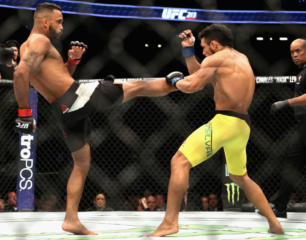 LAS VEGAS, NV - JULY 08: (L-R) <a href='../fighter/Rob-Font'>Rob Font</a> kicks <a href='../fighter/Douglas-Silva-de-Andrade'>Douglas Silva de Andrade</a> of Brazil in their bantamweight bout during the UFC 213 event at T-Mobile Arena on July 8, 2017 in Las Vegas, Nevada. (Photo by Christian Petersen/Zuffa LLC)“ align=“center“/>Bantamweight contender Rob Font impressed in his elevation to the Pay-Per-View main card, as he used his striking to set up a second round submission of Douglas Silva de Andrade.</p><p>Font has talked of using his ground game more, and he proved it in the first minute of the opening round as he took Silva to the mat. Silva rose quickly and got loose after nearly getting caught in a guillotine choke. A combination by Font rattled Silva, but an inadvertent eye poke followed, giving the Brazilian time to recover. When the bout resumed, Silva scored with some hard strikes, but Font regained control by the end of the round.</p><p>The technically sound Font continued to stay a step ahead of Silva in round two, and his accurate shots were taking their toll on the Para native, who got rocked bad with a right hand with 90 seconds left. After that, the fight went to the mat, and as Silva tried to slam his way out of trouble, Font locked in a guillotine choke that forced the tap out at 4:36.</p><p>With the win, the No. 15-ranked Font moves to 14-2; Silva de Andrade falls to 24-2 with 1 NC.</p></div><footer><div class=