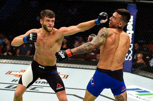  ANAHEIM, CA - JULY 29: Calvin Kattar punches Andre Fili in their featherweight bout during the UFC 214 event at Honda Center on July 29, 2017 in Anaheim, California. (Photo by Josh Hedges/Zuffa LLC/Zuffa LLC via Getty Images)