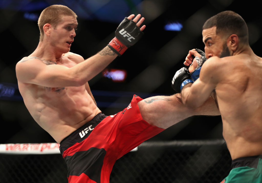 LAS VEGAS, NV - JULY 08: (L-R) <a href='../fighter/Jordan-Mein'>Jordan Mein</a> kicks <a href='../fighter/Belal-Muhammad'>Belal Muhammad</a> in their welterweight bout during the UFC 213 event at T-Mobile Arena on July 8, 2017 in Las Vegas, Nevada. (Photo by Christian Petersen/Zuffa LLC)“ align=“center“/>Welterweight up and comer Belal Muhammad put together a disciplined effort in pounding out a three-round unanimous decision victory over Canadian vet Jordan Mein.</p><p>Mein (29-12) fed Muhammad (12-2) a steady diet of leg kicks through the first five minutes, but the Chicagoan kept marching forward, and when he was able to tie Mein up against the fence, he was able to open a cut over his opponent’s left eye and land several hard shots.</p><p>Muhammad’s pressure continued to be a significant factor in round two, as Mein began slowing down. This led to a late takedown that put a cap on a dominant frame for “Remember the Name,” and he kept the heat on in the final stanza, with his ground game being the key as he won the fight by scores of 29-28 twice and 30-27.</p><p><strong><a href=