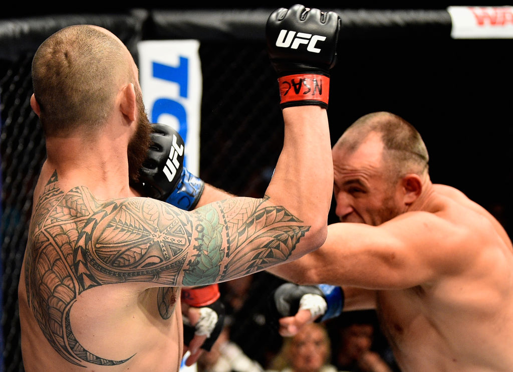 LAS VEGAS, NV - JULY 08: (R-L) <a href='../fighter/Oleksiy-Oliynyk'>Aleksei Oleinik</a> of Russia punches <a href='../fighter/Travis-Browne'>Travis Browne</a> in their heavyweight bout during the UFC 213 event at T-Mobile Arena on July 8, 2017 in Las Vegas, Nevada. (Photo by Jeff Bottari/Zuffa LLC)“ align=“center“/>Russian submission artist Aleksei Oleinik continued to impress in UFC 213 prelim action at T-Mobile Arena in Las Vegas on Saturday, as the No. 14-ranked “Boa Constrictor” forced No. 9-ranked Travis Browne to tap out in the second round of their heavyweight bout.</p><p>There was no shortage of action in the first round, with Browne (19-6-1) getting out to an early lead as he peppered Oleinik (52-10-1) with kicks from long range and then decked him with a left punch in the second minute. But Oleinik was far from done, and just past the midway point of the frame, he evened the score with a right hand that put the big man on the deck. Browne rose, but he was in trouble once again in the closing minute as Oleinik took him down and looked for submissions.</p><p>Browne got a takedown in the second minute of round two, but Oleinik stayed busy from the bottom and fought his way back to the feet. Once standing, Oleinik dragged Browne to the mat and took his opponent’s back. The Russian got Browne back in trouble immediately, and as he sunk in a choke, “Hapa” tapped out at 3:44 of the second frame. The loss was Browne’s fourth in a row.</p><p><strong><a href=