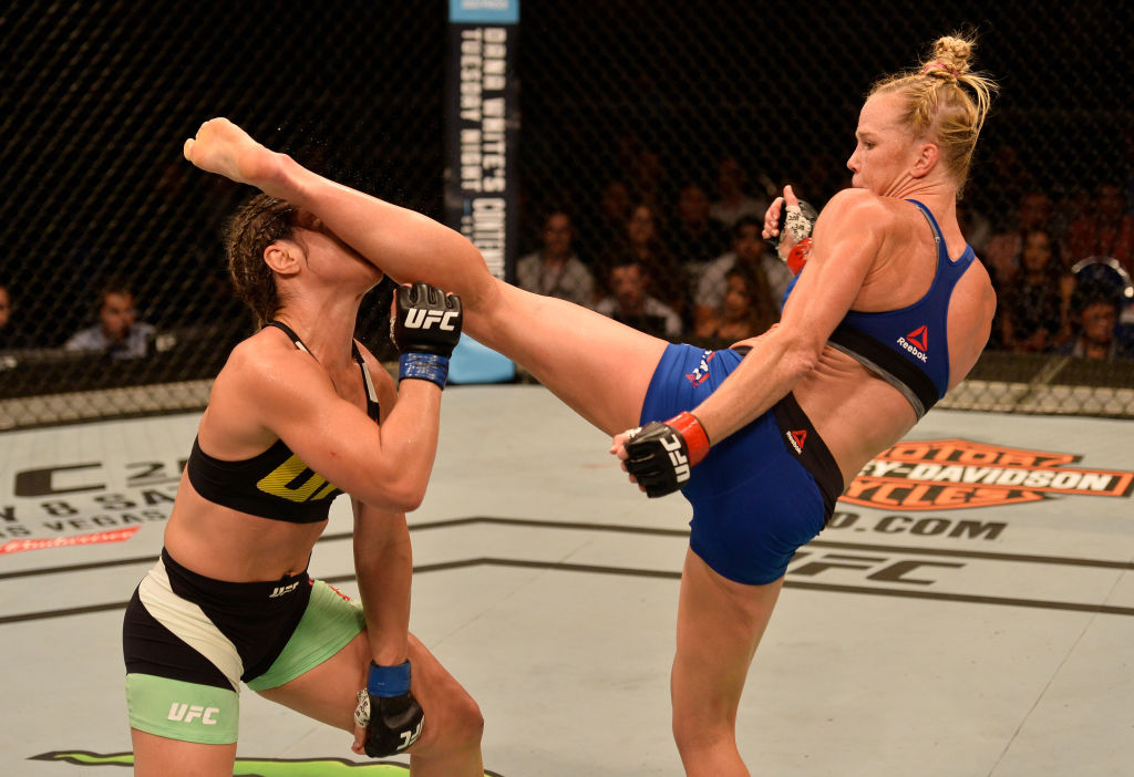 Holly Holm kicks Bethe Correia during their bout at Fight Night Singapore