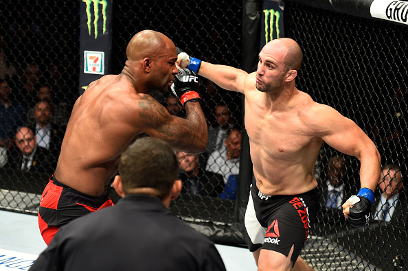 Volan Oezdemir punches Jimi Manuwa during their light heavyweight bout at UFC 214