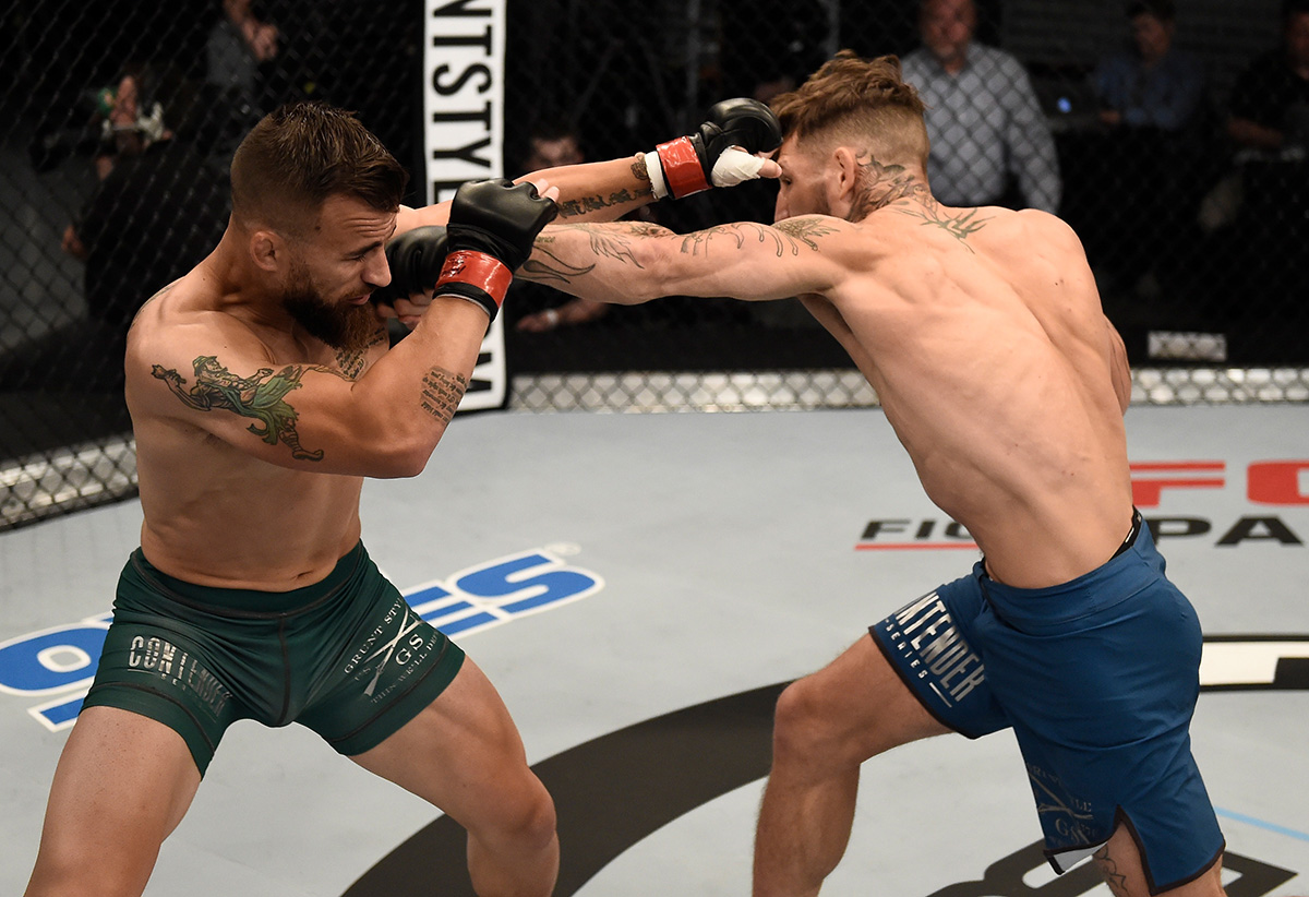 LAS VEGAS, NV - AUGUST 22: (R-L) Mike Santiago punches Mark Cherico in their featherweight bout during Dana White's Tuesday Night Contender Series at the TUF Gym on August 22, 2017 in Las Vegas, Nevada. (Photo by Brandon Magnus/DWTNCS)