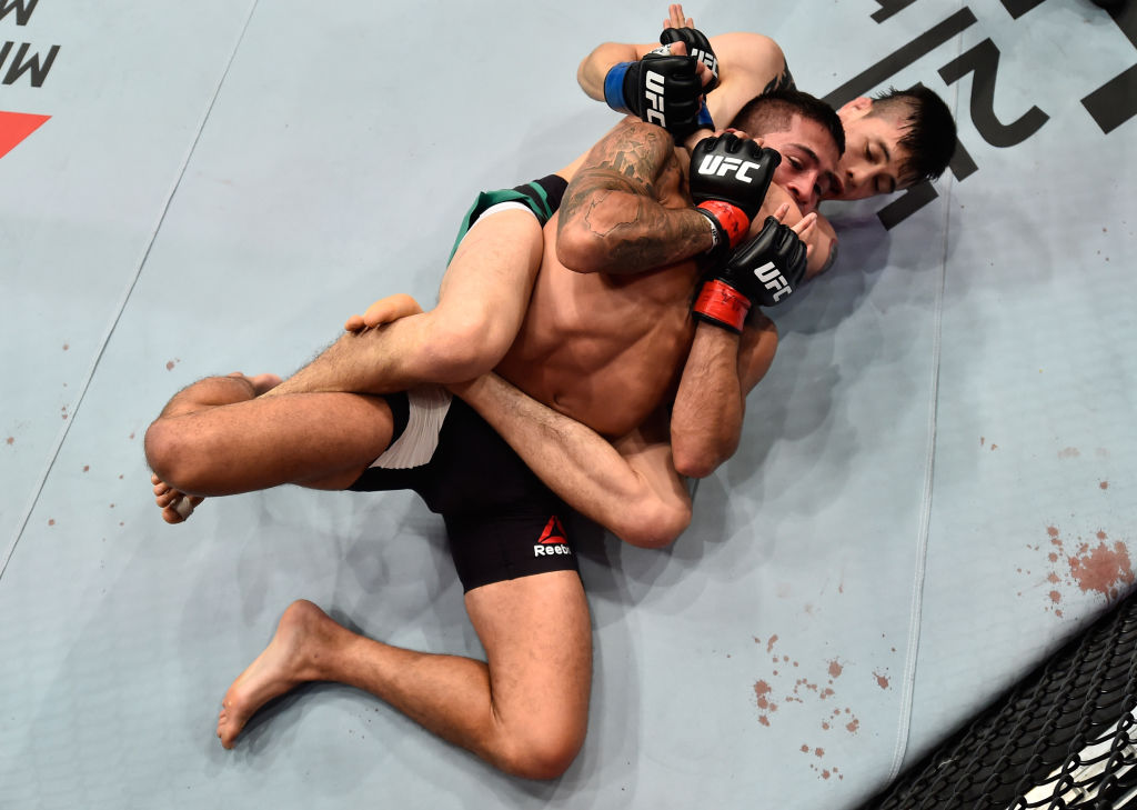 MEXICO CITY, MEXICO - AUGUST 05: Brandon Moreno of Mexico (bottom) attempts to submit Sergio Pettis in their flyweight bout during the UFC Fight Night event at Arena Ciudad de Mexico on August 5, 2017 in Mexico City, Mexico. (Photo by Jeff Bottari/Zuffa LLC)