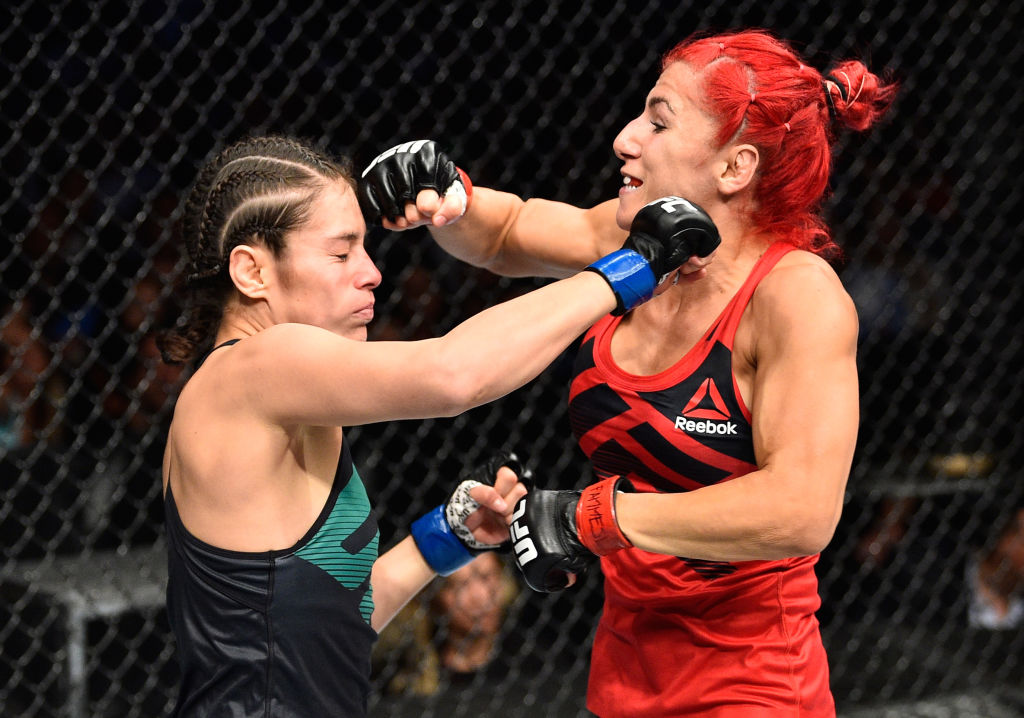 MEXICO CITY, MEXICO - AUGUST 05: (L-R) Alexa Grasso of Mexico punches Randa Markos of Iraq in their women's strawweight bout during the UFC Fight Night event at Arena Ciudad de Mexico on August 5, 2017 in Mexico City, Mexico. (Photo by Jeff Bottari/Zuffa LLC)