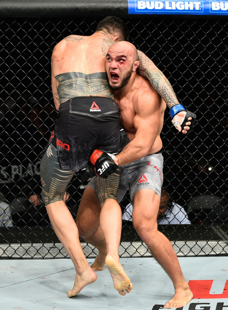 EDMONTON, AB - SEPTEMBER 09: (R-L) <a href='../fighter/Ilir-Latifi'>Ilir Latifi</a> of Sweden takes down <a href='../fighter/tyson-pedro'>Tyson Pedro</a> of Australia in their light heavyweight bout during the UFC 215 event inside the Rogers Place on September 9, 2017 in Edmonton, Alberta, Canada. (Photo by Jeff Bottari/Zuffa LLC)“ align=“left“/>Returning Ilir Latifi put in a workmanlike effort for 15 minutes against Australia’s Tyson Pedro in their clash of light heavyweight contenders, winning a hard-fought unanimous decision in his first fight since September 2016.</p><p>Scores were 29-28 twice and 30-27.</p><p>Latifi got a takedown in the second minute, showing off his world-class wrestling attack. Pedro was able to scramble his way back to his feet and the two traded hard shots, the Aussie getting the better of the exchange. Pedro almost landed a head kick that would have surely ended the fight, but Latifi ducked under and got another takedown, Again, Latifi tried to work from the north-south position, but Pedro exploded back to his feet once more. Latifi kept the pressure on, though, pushing Pedro past the 4:10 mark for the first time in his career.</p><p>After battling back and forth early in round two, Latifi scored a takedown with a little over two minutes left, and the Malmo product scored with some hard punches while Pedro was pinned against the fence. Pedro made it back to his feet with Latifi still locked on to him, and even though he got some elbows in, it was a solid round for “The Sledgehammer.”</p><p>Pedro’s strikes began finding their mark more in the final round, and the cut around Latifi’s left eye was getting worse. Latifi’s counters were landing well in response, and midway through the frame, the Sweden native got a key takedown, and soon his ground strikes had marked Pedro’s face up, capping off a solid victory for the No. 10-ranked Latifi, who improves to 14-5 with 1 NC. The No. 13-ranked Pedro falls to 6-1.</p><p><strong>STEPHENS vs MELENDEZ</strong></p><blockquote class=