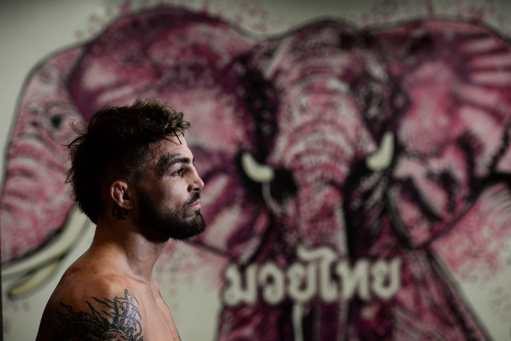 <a href='../fighter/mike-perry'>Mike Perry</a> speaks to the media after an open workout session on September 14, 2017 in Pittsburgh, Pennsylvania. (Photo by Brandon Magnus/Zuffa LLC)“ align=“center“/>Talk to Mike Perry for any length of time, and you’ll realize that there are two sides to the brash knockout artist. But he doesn’t necessarily agree.<p>“Yeah, there’s probably a couple more than that,” he laughs. It’s a little over a week away from this Saturday’s <a href=