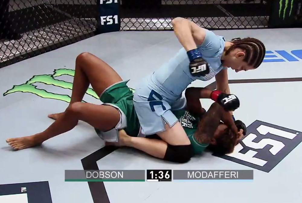 Modafferi punches Raquel Pennington during their bout in 2013
