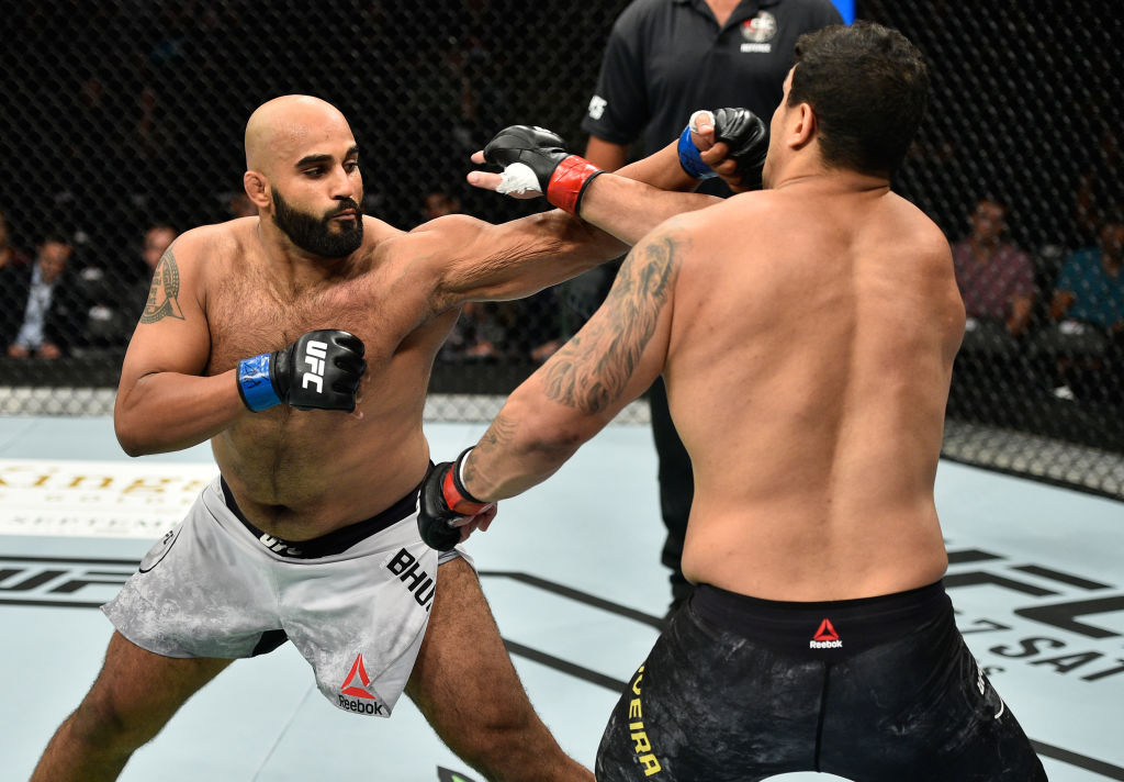 EDMONTON, AB - SEPTEMBER 09: (L-R) <a href='../fighter/Arjan-Bhullar'>Arjan Singh Bhullar</a> of Canada punches <a href='../fighter/luis-henrique'>Luis Henrique</a> of Brazil in their heavyweight bout during the UFC 215 event inside the Rogers Place on September 9, 2017 in Edmonton, Alberta, Canada. (Photo by Jeff Bottari/Zuffa LLC)“ align=“center“/>2012 Canadian Olympic team wrestler Arjan Singh Bhullar made a successful UFC debut, as he won a close, but unanimous decision over Brazil’s Luis Henrique in heavyweight action.</p><p>Bhullar pressured Henrique throughout the first five minutes, landing a right hand that was the best punch of the round. Henrique was patient, though, and he avoided a takedown from the Olympic wrestler, which was a moral victory of sorts.</p><p>Two minutes into the second round, Bhullar’s right hand struck again, this time producing a knockdown. Henrique got to his feet, but Bhullar slammed him to the mat and began firing off ground strikes on the bloodied Brazilian, capping off a big round.</p><p>Looking to turn things around in the final frame, Henrique went on the offensive in the third, and he landed several hard kicks and did good work in the clinch, allowing him to take the round, but not the fight, which went to Bhullar by three scores of 29-28.</p><p>With the win, Bhullar moves to 7-0; Henrique falls to 10-4 with 1 NC.</p><p><strong>JOHNSON vs MARTINS</strong></p><blockquote class=