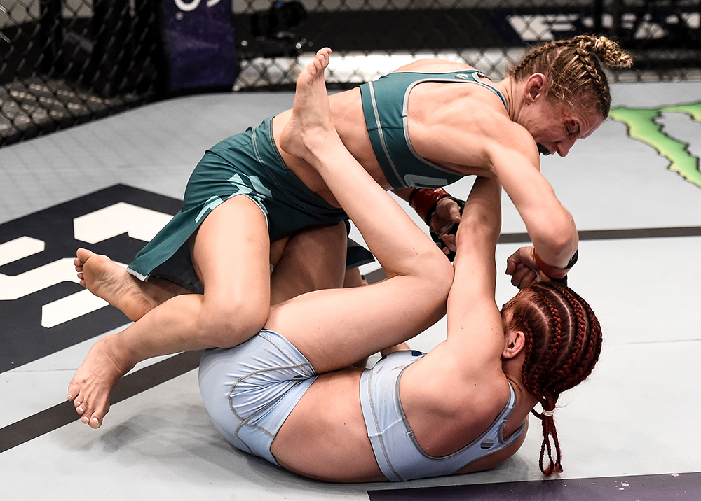 Barb Honchak lands an elbow against Gillian Robertson during their bout on The Ultimate Fighter