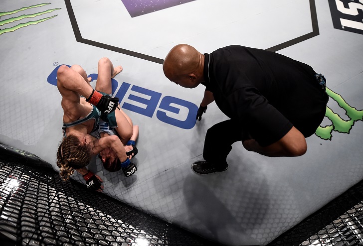 Barb Honchak punches Gillian Robertson from the top position during their bout on The Ultimate Fighter