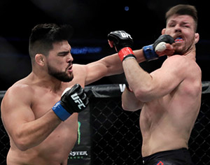 Kelvin Gastelum punches Michael Bisping during the UFC Fight Night at Mercedes-Benz Arena on November 25, 2017 in Shanghai, China. (Photo by Hu Chengwei/Getty Images)