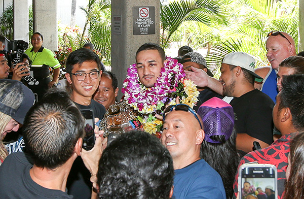 Max Holloway (center) is surrounded by fans after arriving at the Daniel K. Inouye International Airport on June 5, 2017 in Honolulu, Hawaii. Holloway became the the undisputed UFC Featherweight Champion after beating Jose Aldo. (Photo by Zuffa LLC)
