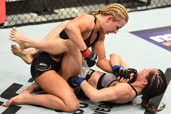 (L-R) <a href='../fighter/amanda-cooper'>Amanda Cooper</a> punches <a href='../fighter/Angela-Magana'>Angela Magana</a> in their women’s strawweight bout during the UFC 218 event inside Little Caesars Arena on December 02, 2017 in Detroit, Michigan. (Photo by Josh Hedges/Zuffa LLC)“ align=“center“/> Bath, Michigan’s Amanda Cooper thrilled her fans in Detroit, halting Angela Magana in the second round of a clash between strawweight alums of <a href=