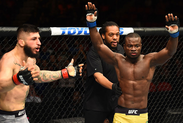 (R-L) <a href='../fighter/Abdul-Razak-Alhassan'>Abdul Razak Alhassan</a> of Ghana reacts after referee Herb Dean stopped the fight against <a href='../fighter/sabah-homasi'>Sabah Homasi</a> in their welterweight bout during the UFC 218 event inside Little Caesars Arena on December 02, 2017 in Detroit, Michigan. (Photo by Josh Hedges/Zuffa LLC)“ align=“center“/> An entertaining welterweight scrap between Abdul Razak Alhassan and Sabah Homasi met an abbreviated end, with Alhassan picking up his second UFC victory via first-round TKO.</p><p>The power shots were flying from the start, with Homasi (11-7) scoring first, but Alhassan (8-1) was firing back even harder. Homasi recovered quick and jarred Alhassan before landing a takedown, but after eating a couple hard elbows, the Ghana native got back to his feet. The two went on to battle at close range against the fence, and during a furious exchange, Homasi got clipped while going for a takedown, and referee Herb Dean halted the fight, much to the dismay of Homasi and the fans in attendance. The official time was 4:21.</p><p><strong>REYES vs KIMBALL</strong></p><p><img class=
