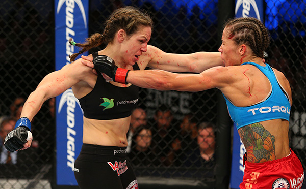 (L-R) Alexis Davis punches Liz Carmouche in their UFC women's bantamweight bout on November 6, 2013 in Fort Campbell, Kentucky. (Photo by Ed Mulholland/Zuffa LLC)