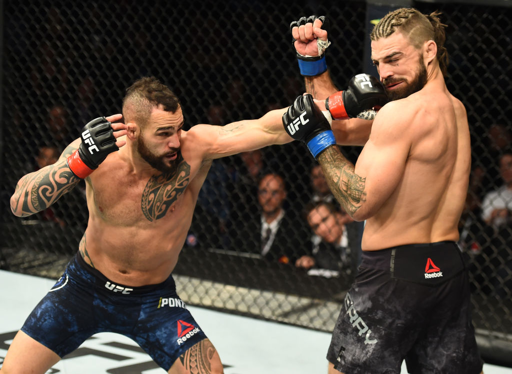 WINNIPEG, CANADA - DECEMBER 16: (L-R) Santiago Ponzinibbio of Argentina punches Mike Perry in their welterweight bout during the UFC Fight Night event at Bell MTS Place on December 16, 2017 in Winnipeg, Manitoba, Canada. (Photo by Josh Hedges/Zuffa LLC)