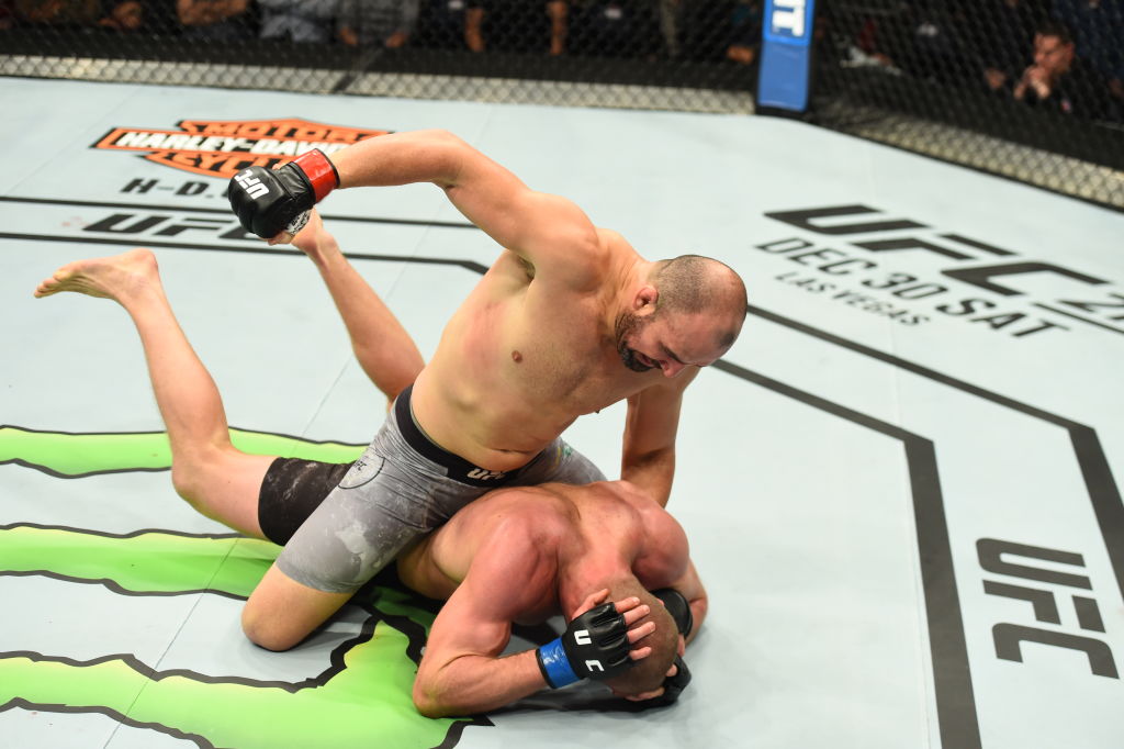 WINNIPEG, CANADA - DECEMBER 16: Glover Teixeira of Brazil (top) punches Misha Cirkunov of Latvia in their light heavyweight bout during the UFC Fight Night event at Bell MTS Place on December 16, 2017 in Winnipeg, Manitoba, Canada. (Photo by Josh Hedges/Zuffa LLC)