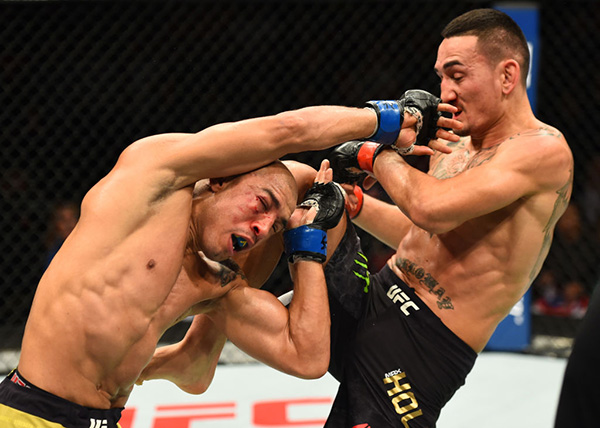(R-L) <a href='../fighter/Max-Holloway'>Max Holloway</a> lands a knee against <a href='../fighter/Jose-Aldo'>Jose Aldo</a> of Brazil in their UFC featherweight championship bout during the UFC 218 event inside Little Caesars Arena on December 02, 2017 in Detroit, Michigan. (Photo by Josh Hedges/Zuffa LLC)“ align=“center“/><strong>HOLLOWAY vs ALDO 2</strong><p>For a long time, it looked like Jose Aldo would never lose his UFC featherweight crown. On Saturday night at Detroit’s Little Caesars Arena, Max Holloway looked like he’s settling in for a long reign of his own as he stopped Aldo for the second time this year, retaining his 145-pound title with a third-round stoppage in the main event of UFC 218.</p><p>The victory was the 25-year-old Holloway’s 12th in a row and first title defense. The 31-year-old Aldo, who replaced the injured <a href=