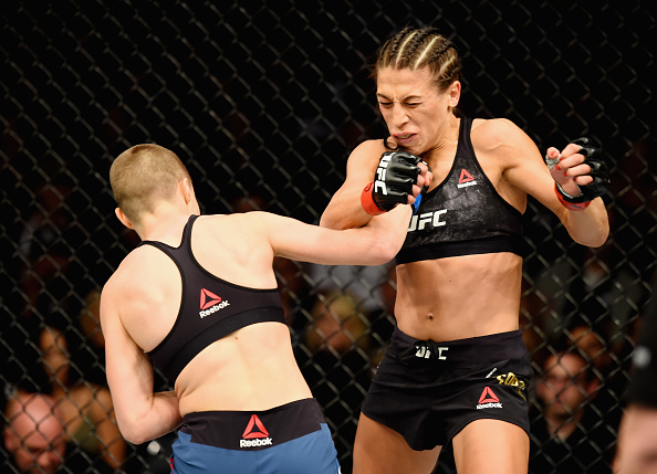 Rose Namajunas punches Joanna Jedrzejczyk during their UFC 215 title fight