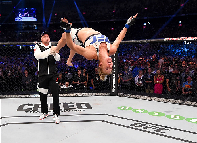 Holly Holm celebrates after defeating Ronda Rousey at UFC 193