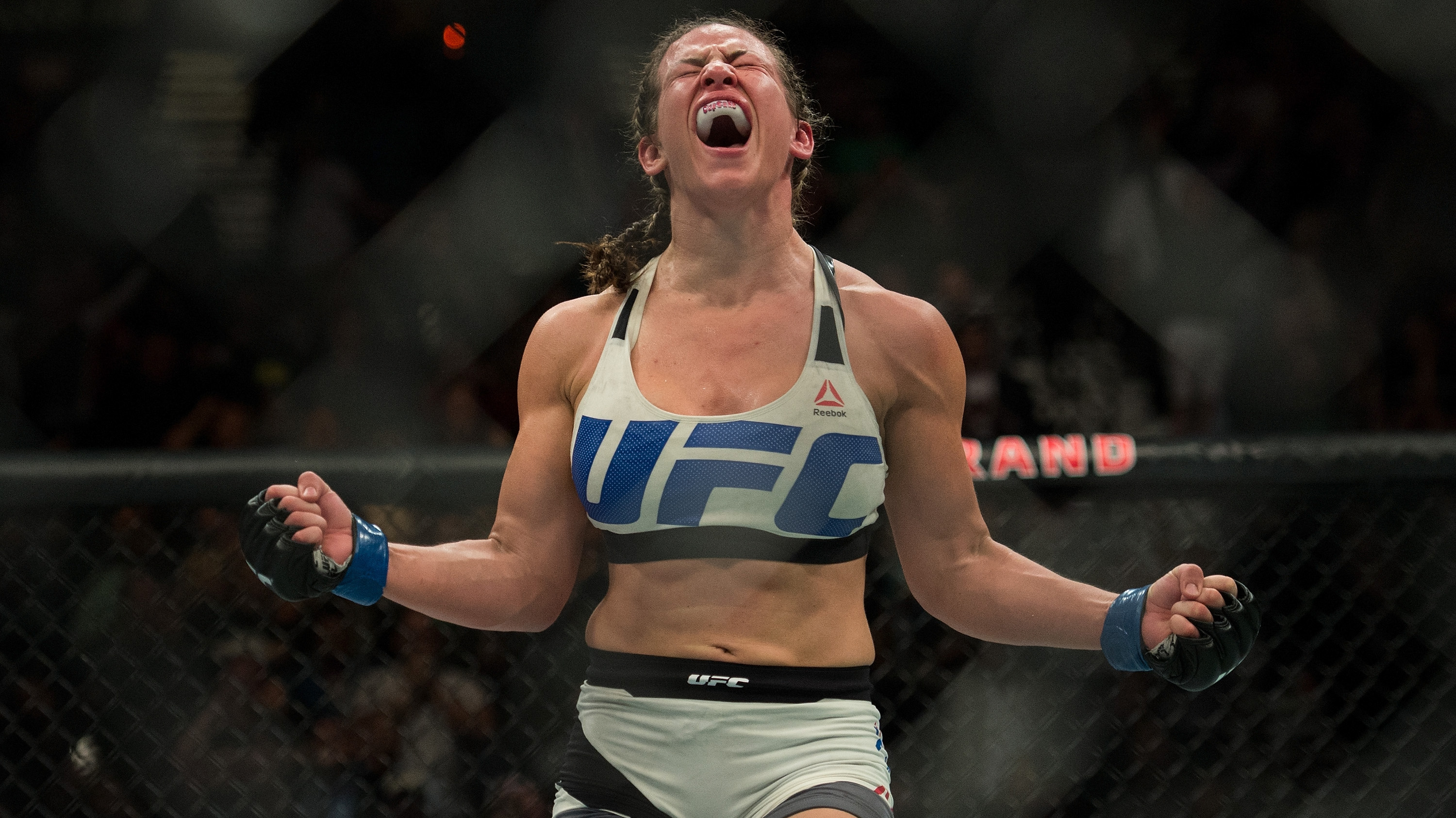 Miesha Tate celebrates after defeating Holly Holm at UFC 196