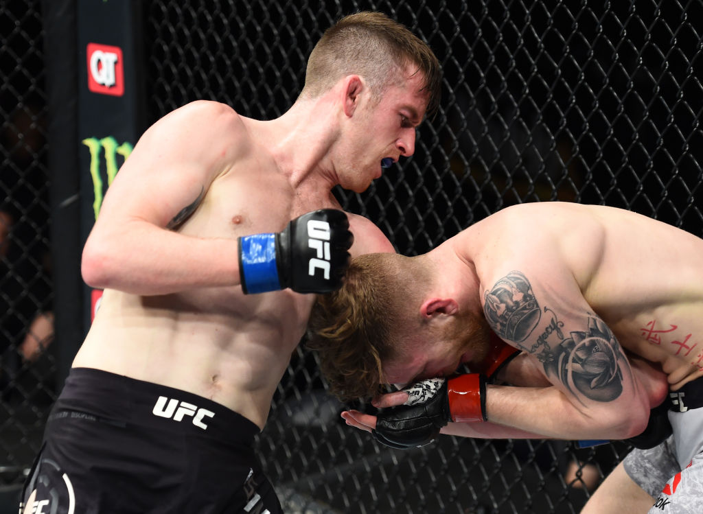 CHARLOTTE, NC - JANUARY 27: (L-R) Cory Sandhagen punches Austin Arnett in their featherweight bout during a UFC Fight Night event at Spectrum Center on January 27, 2018 in Charlotte, NC. (Photo by Josh Hedges/Zuffa LLC)